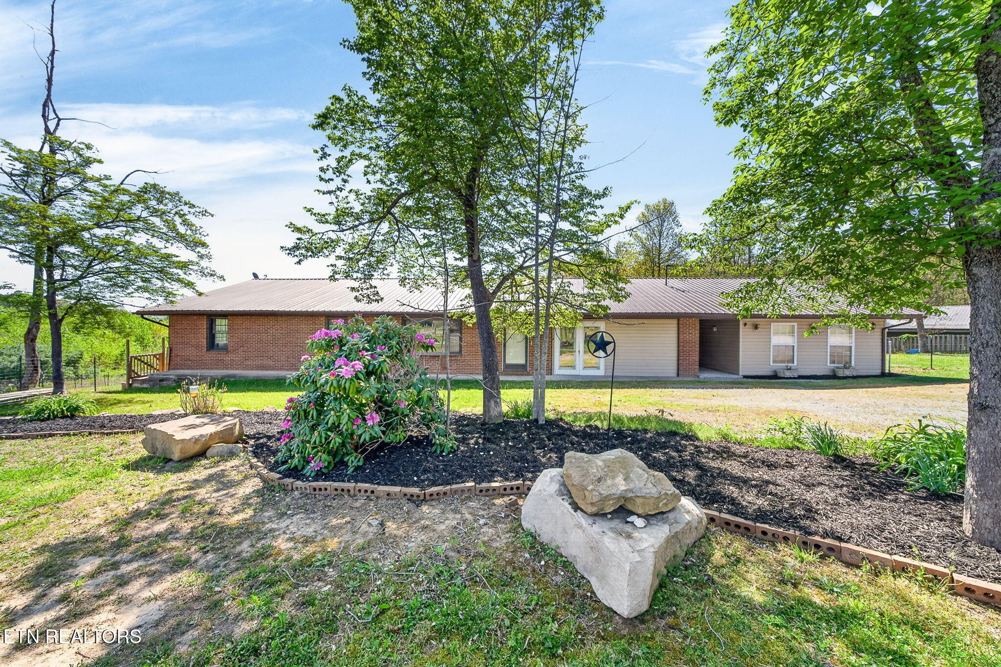 935 Brewer Road Crossville, TN 38572 - Photo 40 of 51 a front view of a house with a yard and a garden