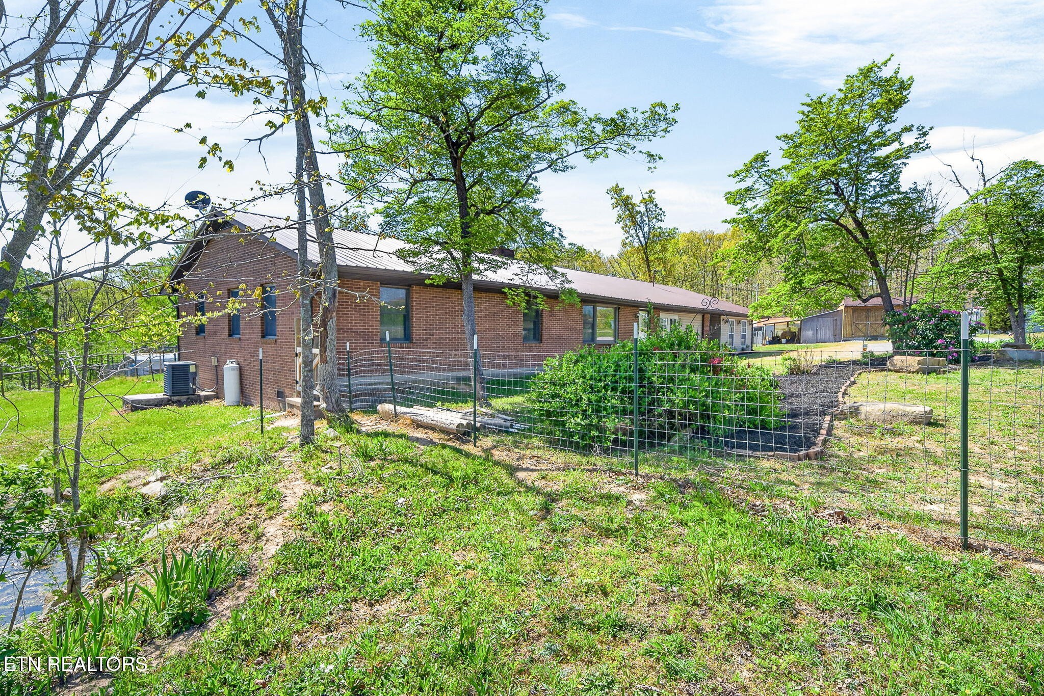 935 Brewer Road Crossville, TN 38572 - Photo 44 of 51 a view of a house with a yard and a large tree