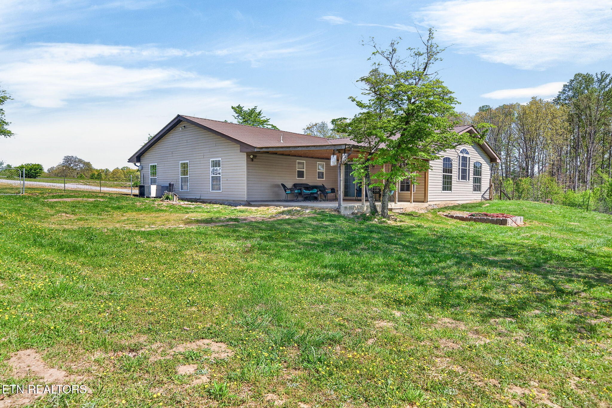 935 Brewer Road Crossville, TN 38572 - Photo 8 of 51 a front view of a house with a yard and trees
