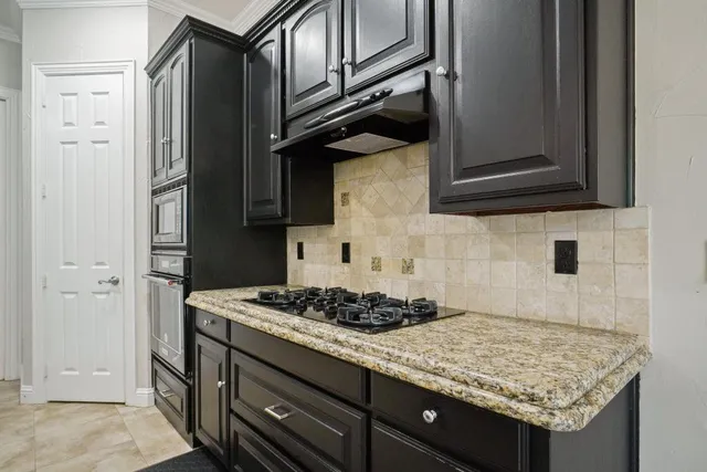 a kitchen with granite countertop cabinets and stove