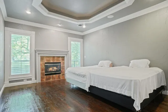 a bedroom with a bed and a fireplace