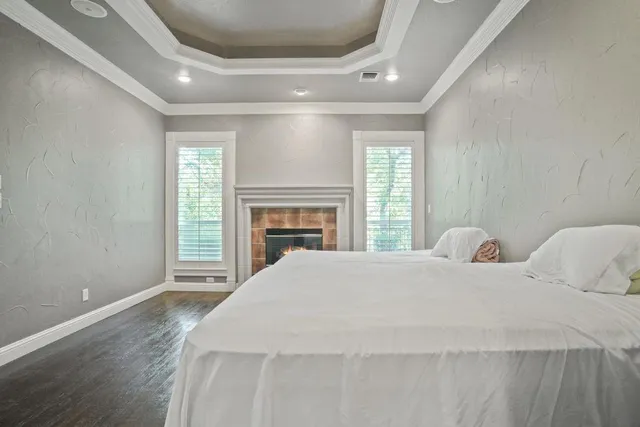 a bedroom with a bed and a fireplace