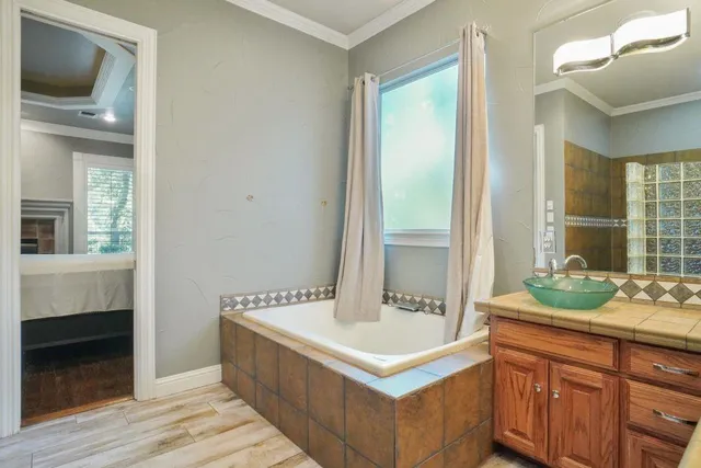 a spacious bathroom with a sink a mirror and a bathtub