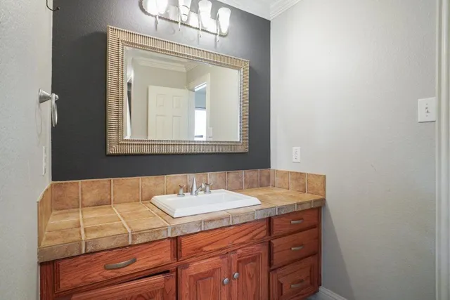 a bathroom with a sink vanity and mirror