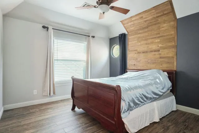 a bedroom with a bed and a window