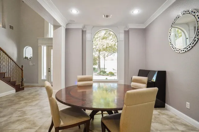 a view of a dining room with furniture and a large window