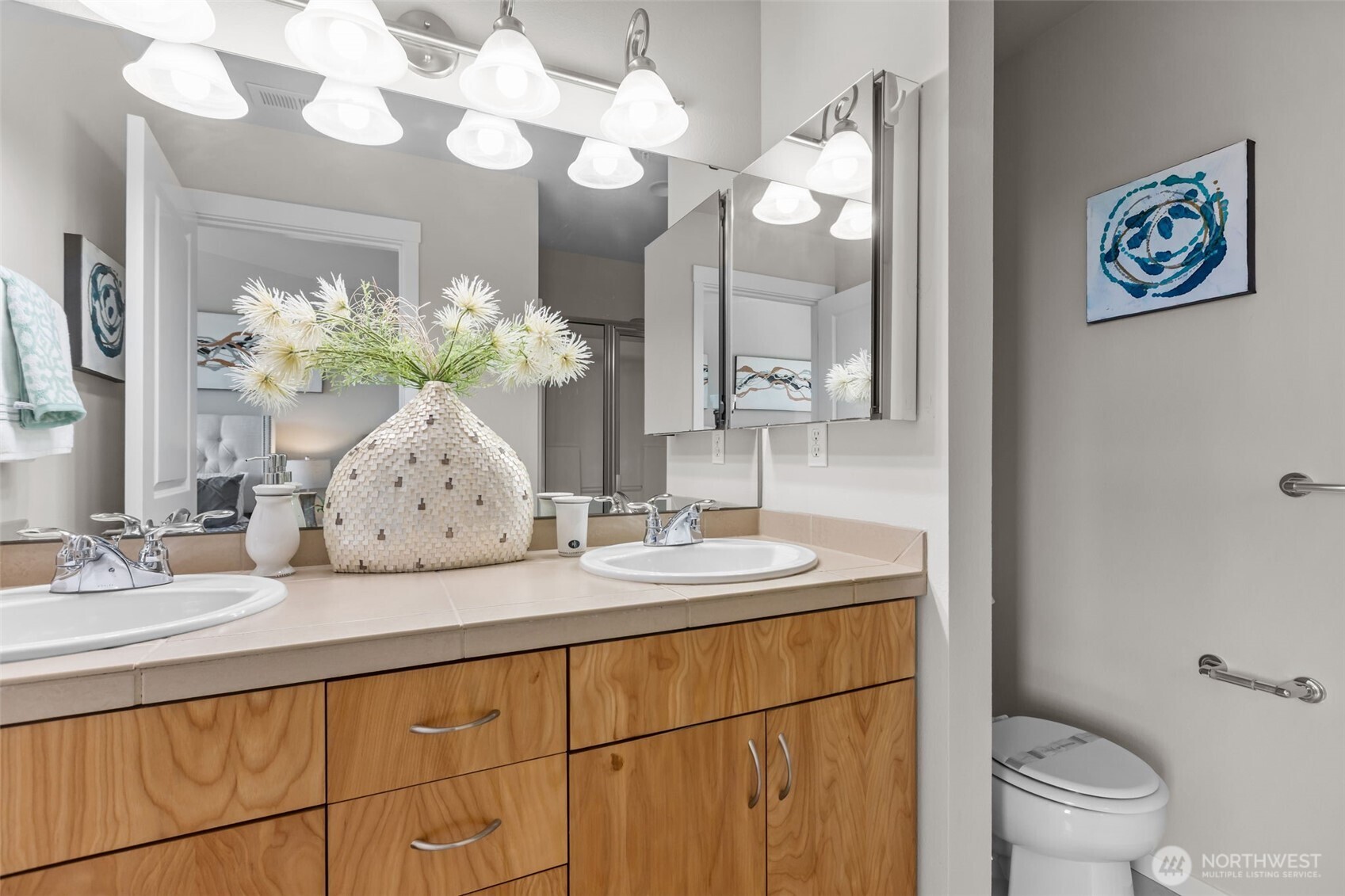 67 Cougar Ridge Road Northwest, Unit 2013 Issaquah, WA 98027 - Photo 16 of 33 a bathroom with a sink a toilet and a mirror