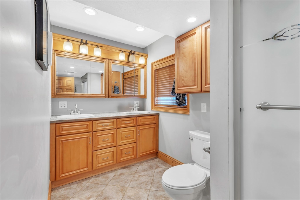 6 Babb Road Southwick, MA 01077 - Photo 29 of 42 a spacious bathroom with a granite countertop toilet sink and mirror