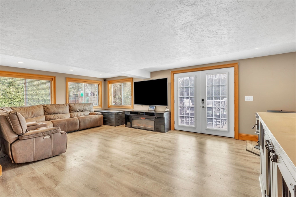 6 Babb Road Southwick, MA 01077 - Photo 32 of 42 a living room with furniture a flat screen tv and a large window