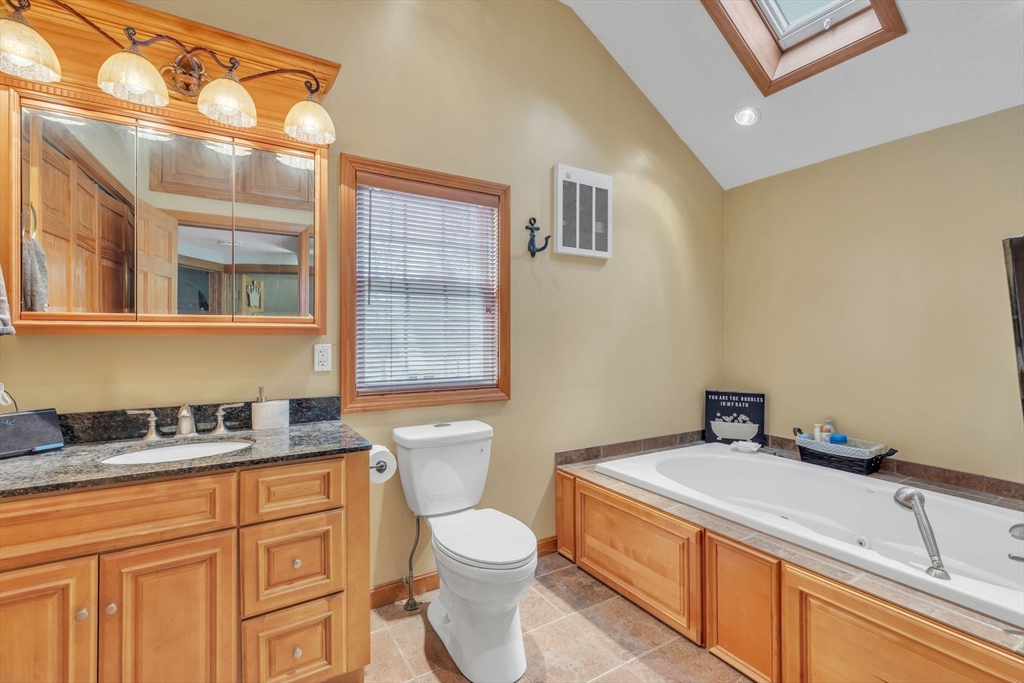 6 Babb Road Southwick, MA 01077 - Photo 35 of 42 a bathroom with a granite countertop sink mirror vanity and toilet