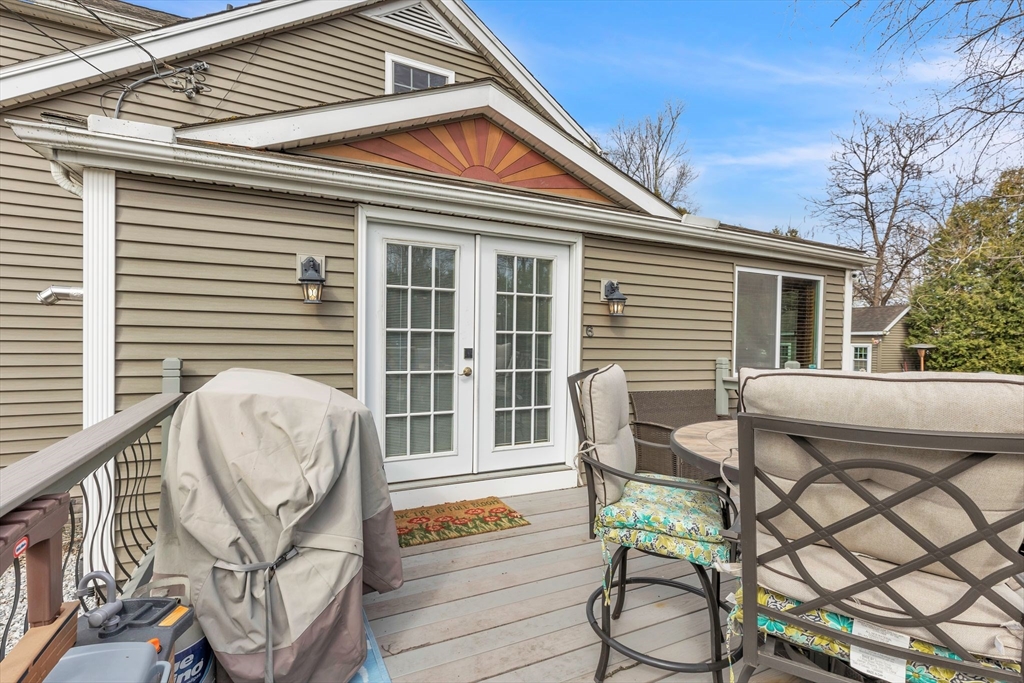 6 Babb Road Southwick, MA 01077 - Photo 41 of 42 a balcony with table and chairs with wooden floor and fence