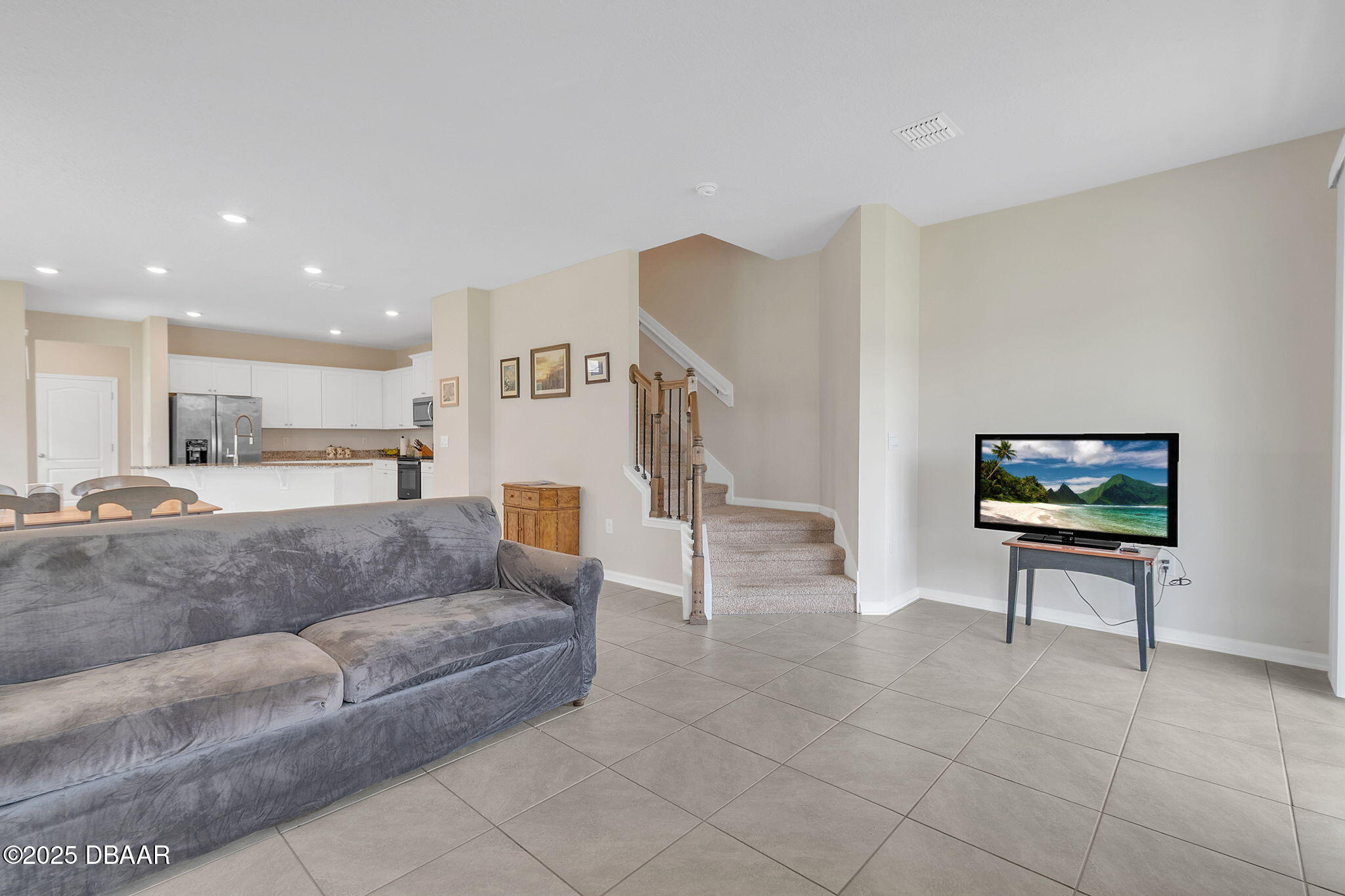144 Redbud Road Palm Coast, FL 32137 - Photo 12 of 47 a living room with furniture and a flat screen tv