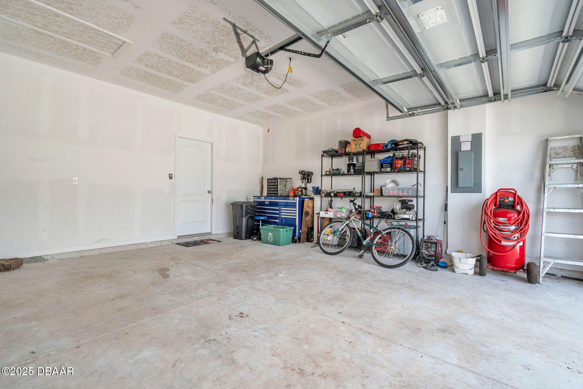 144 Redbud Road Palm Coast, FL 32137 - Photo 27 of 47 a view of a garage with a bike and racks