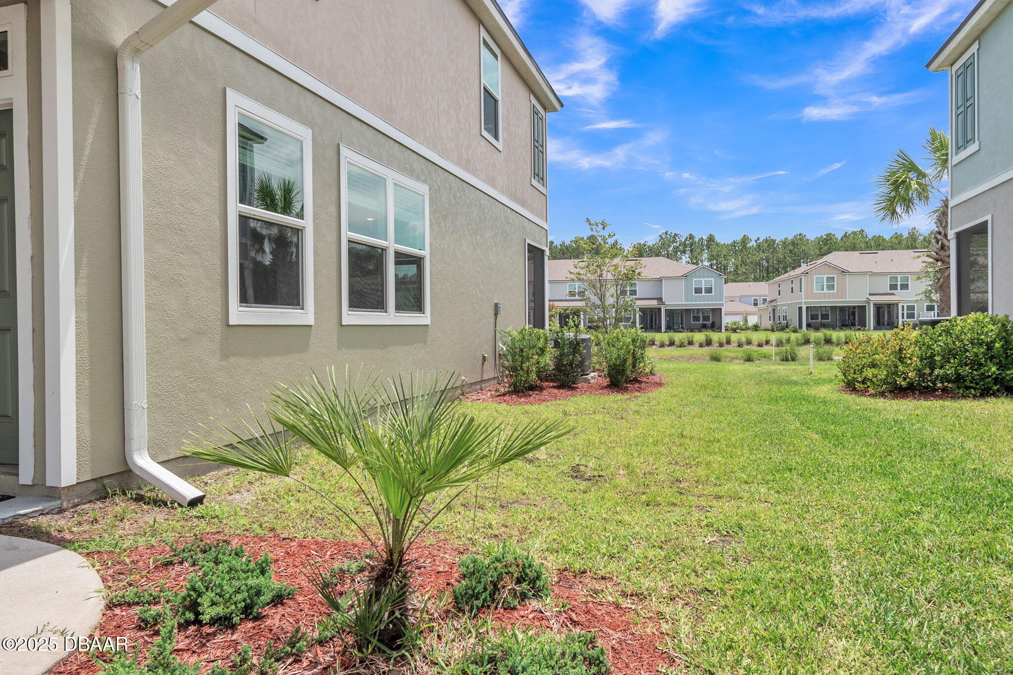 144 Redbud Road Palm Coast, FL 32137 - Photo 35 of 47 a view of a house with a garden