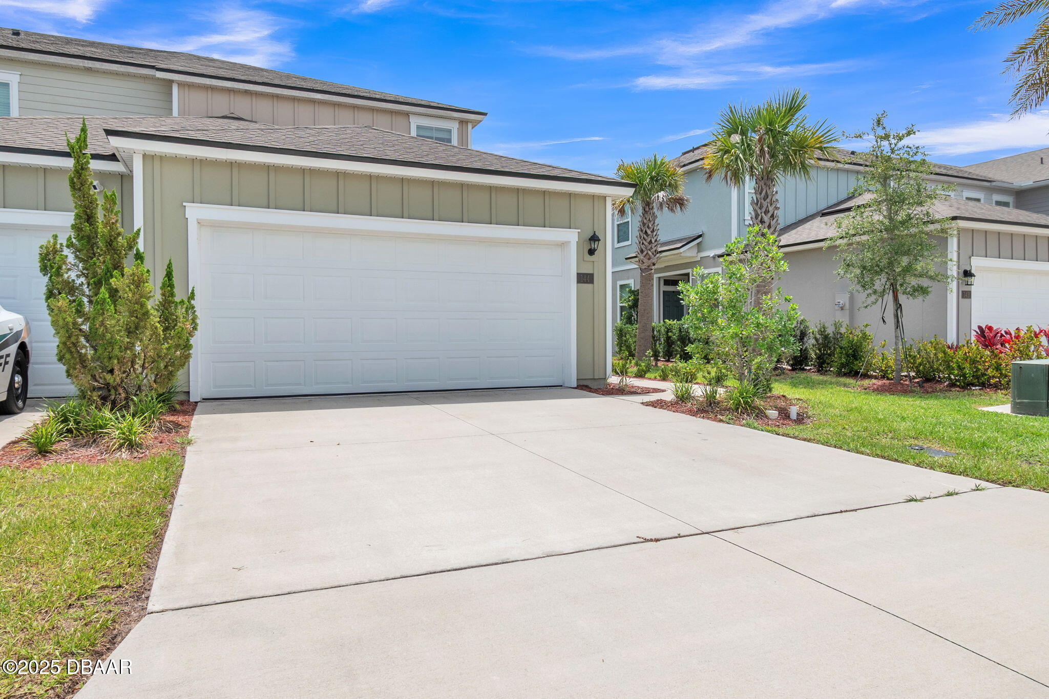 144 Redbud Road Palm Coast, FL 32137 - Photo 46 of 47 a front view of a house with a yard and garage