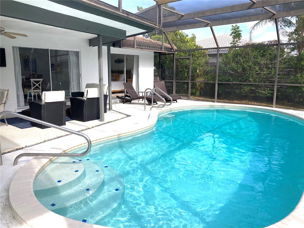 2908 Captiva Drive Sarasota, FL 34231 - Photo 12 of 12 a view of a swimming pool with an outdoor seating