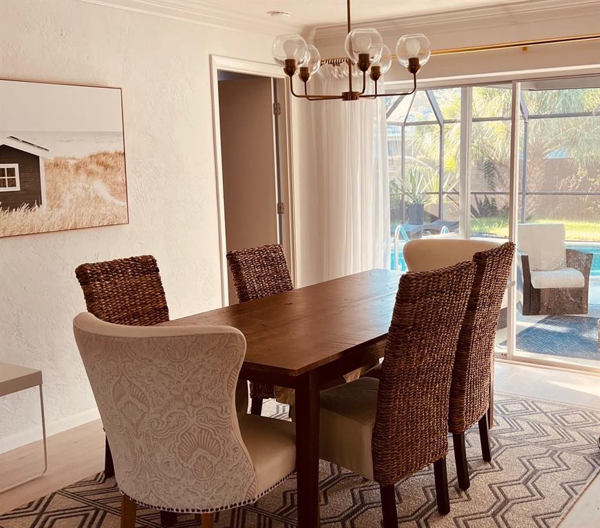 2908 Captiva Drive Sarasota, FL 34231 - Photo 6 of 12 a dining room with furniture and wooden floor