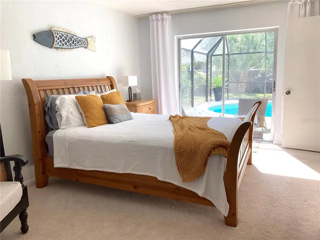 a bedroom with bed and a window