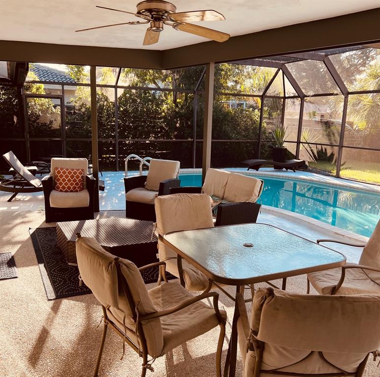 2908 Captiva Drive Sarasota, FL 34231 - Photo 10 of 12 a dining room with furniture and a floor to ceiling window