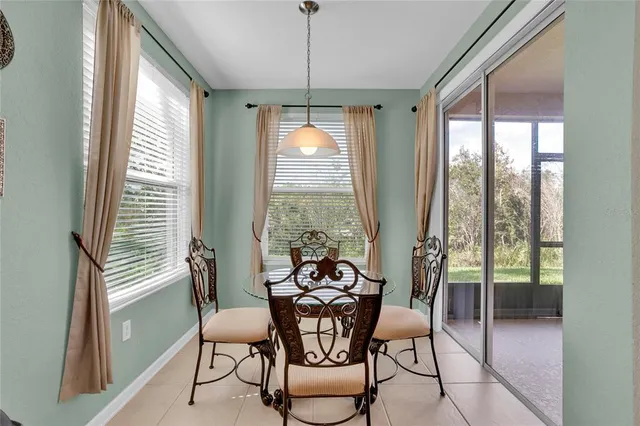 a dining room with furniture window and outside view