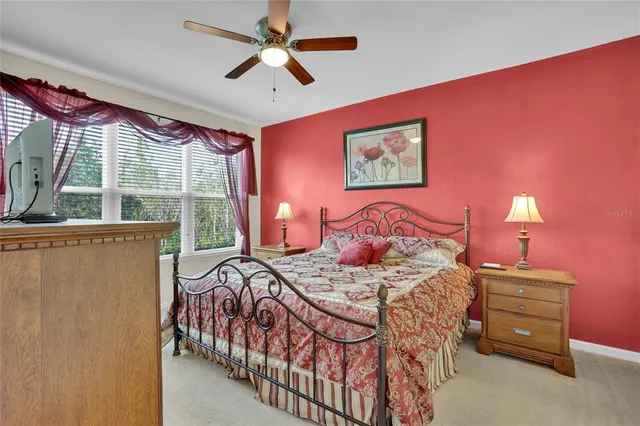 a bedroom with a bed and a large window