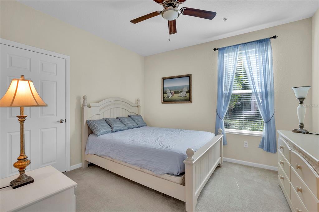 1278 Grady Lane Davenport, FL 33896 - Photo 8 of 17 a bedroom with a bed and a chandelier