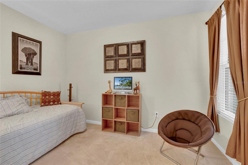 1278 Grady Lane Davenport, FL 33896 - Photo 9 of 17 a bedroom with a bed and a window