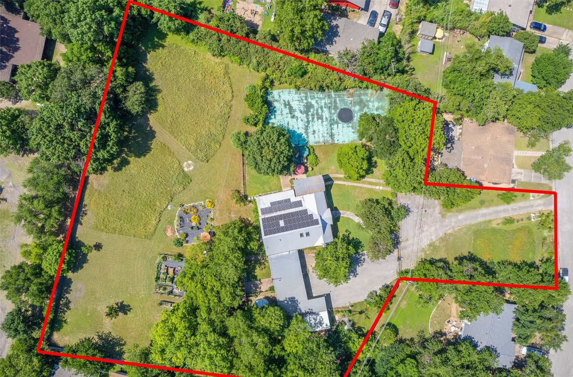 an aerial view of a house with a yard and garden