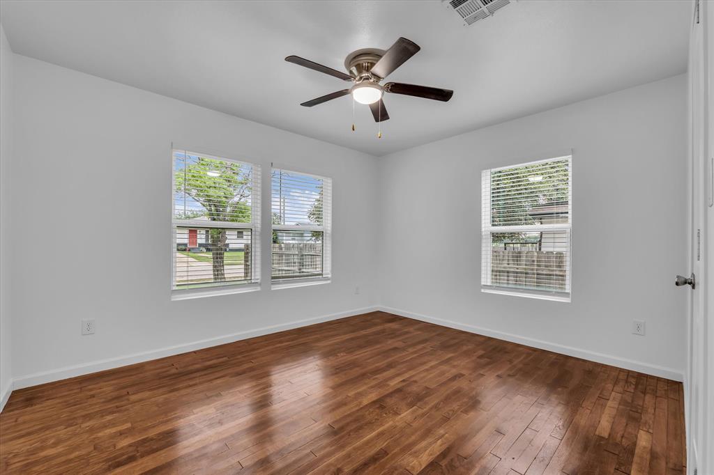 2305 Joey Street Waco, TX 76711 - Photo 14 of 22 a view of an empty room with wooden floor and a window