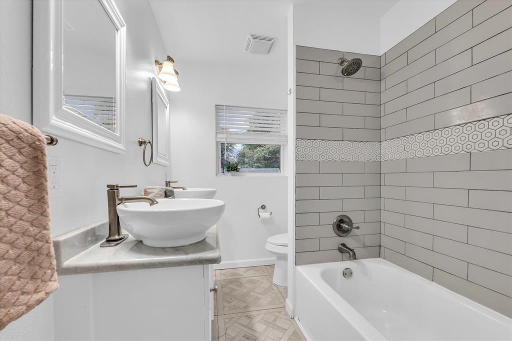 2305 Joey Street Waco, TX 76711 - Photo 15 of 22 a white bath tub sitting next to a white sink