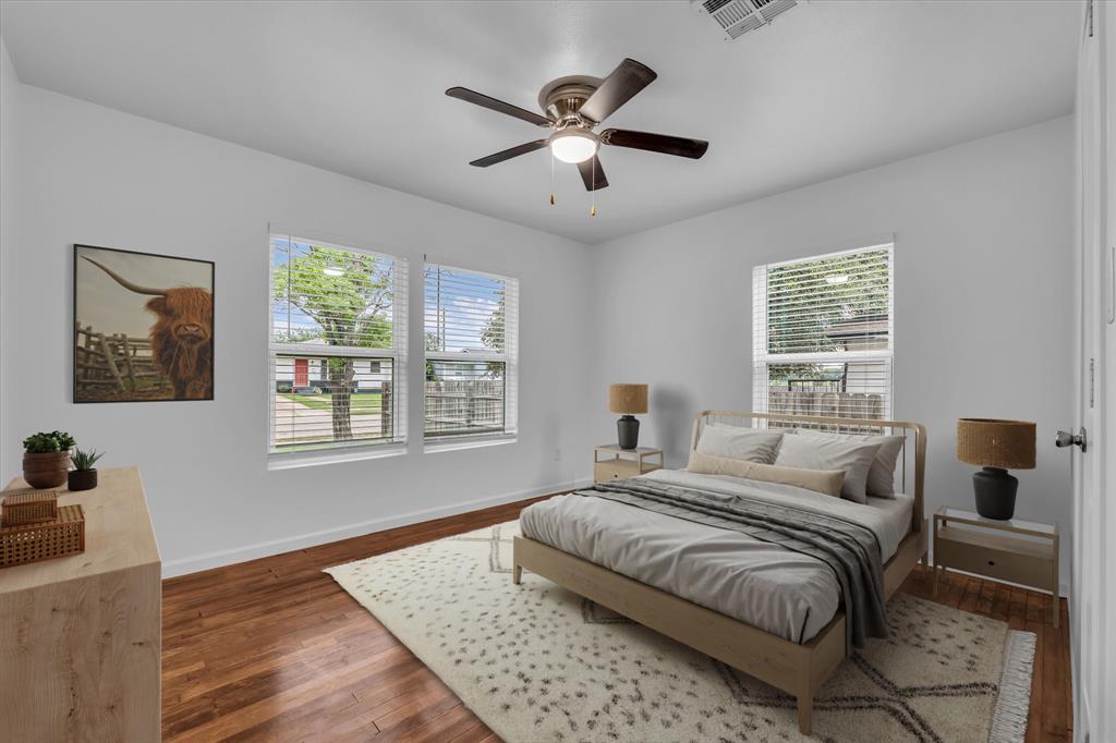 2305 Joey Street Waco, TX 76711 - Photo 3 of 22 a bedroom with a large bed and two windows