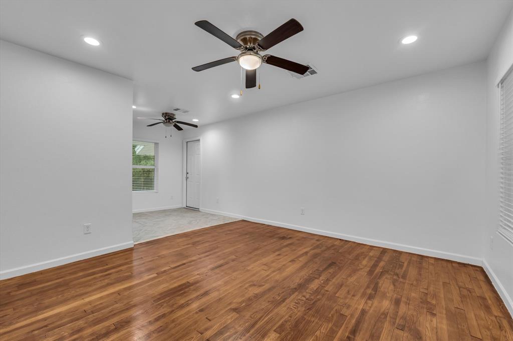 2305 Joey Street Waco, TX 76711 - Photo 8 of 22 an empty room with wooden floor and a ceiling fan