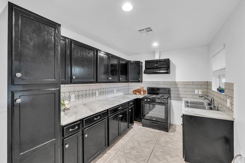 2305 Joey Street Waco, TX 76711 - Photo 9 of 22 a kitchen with stainless steel appliances granite countertop a sink stove and refrigerator