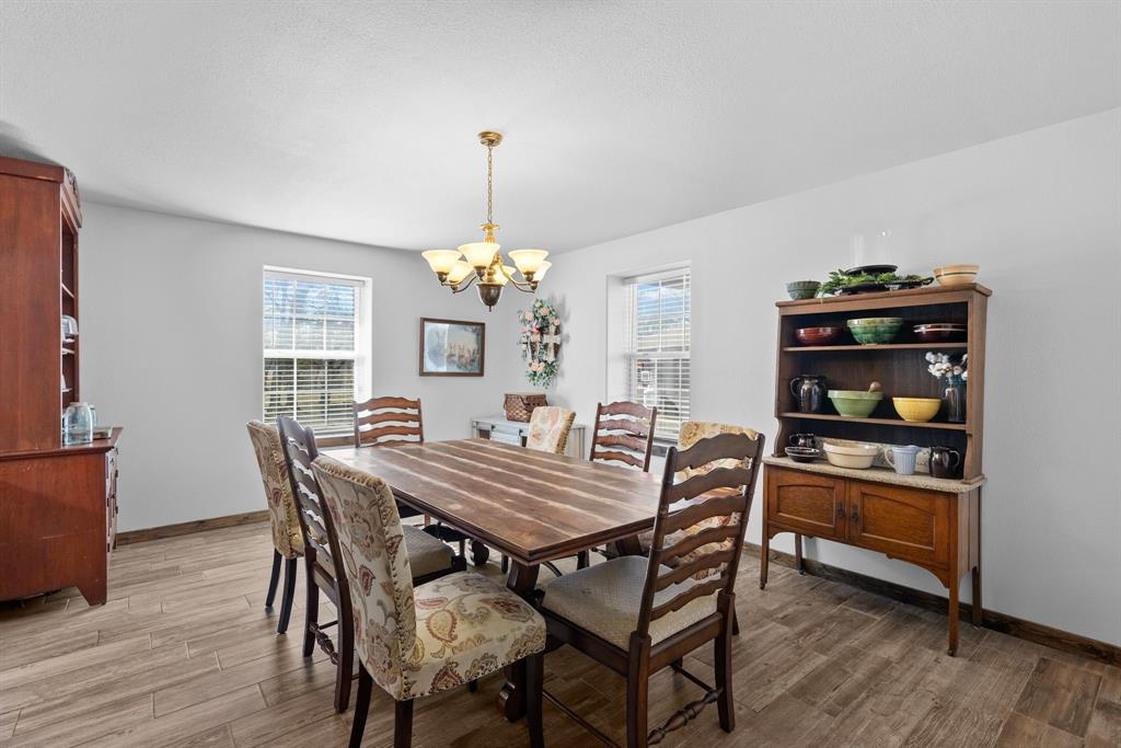 24 County Rd NW 1060 Talco, TX 75487 - Photo 14 of 40 a view of a dining room with furniture and wooden floor