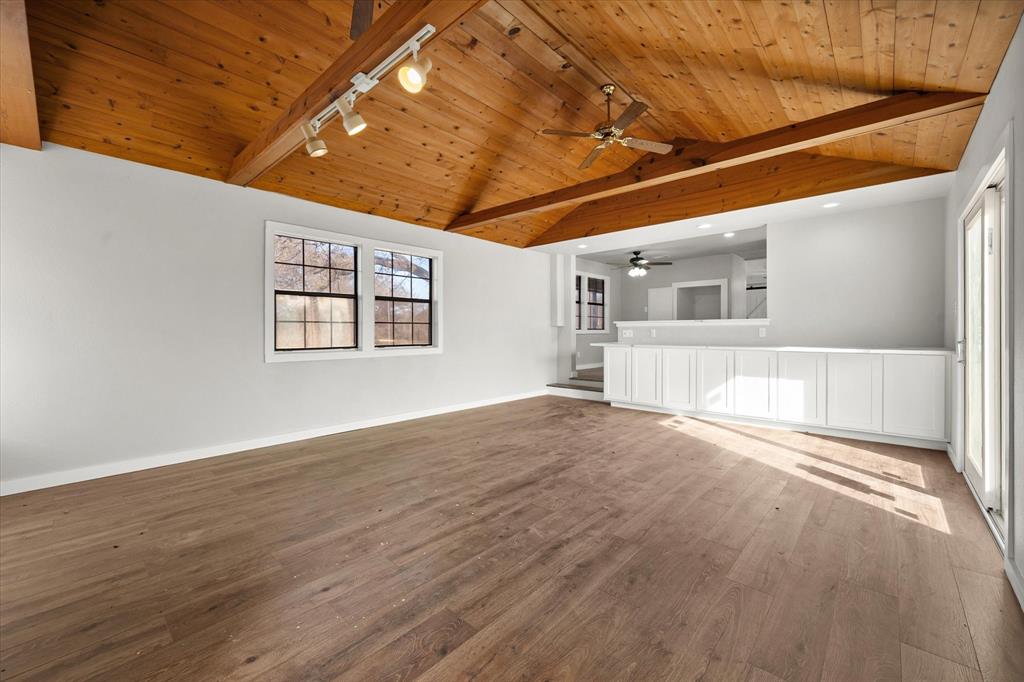 443 County Road 3799 Springtown, TX 76082 - Photo 6 of 33 Unfurnished living room with rail lighting, wood ceiling, hardwood / wood-style flooring, and a ceiling fan