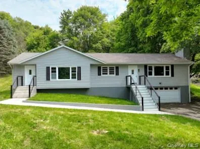 a front view of a house with a yard table and chairs