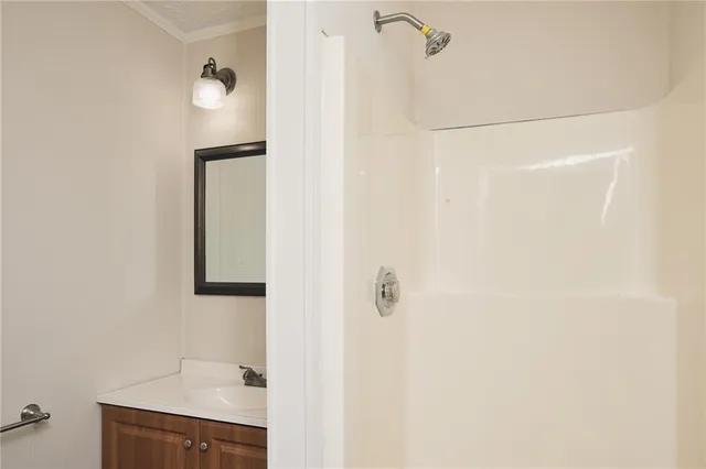 a bathroom with a shower and a sink