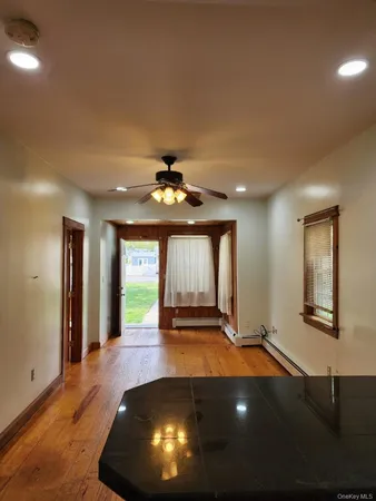 a view of an entryway with wooden floor
