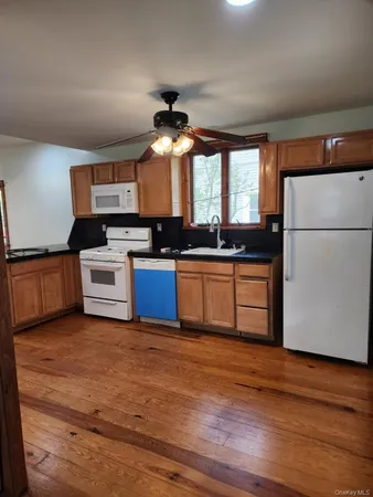 a kitchen with stainless steel appliances granite countertop a stove cabinets and wooden floor