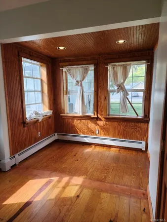 an empty room with large windows
