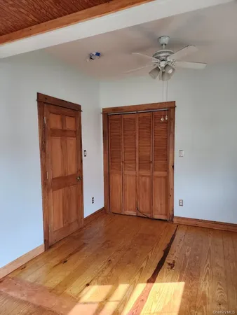 a view of an entryway with wooden floor