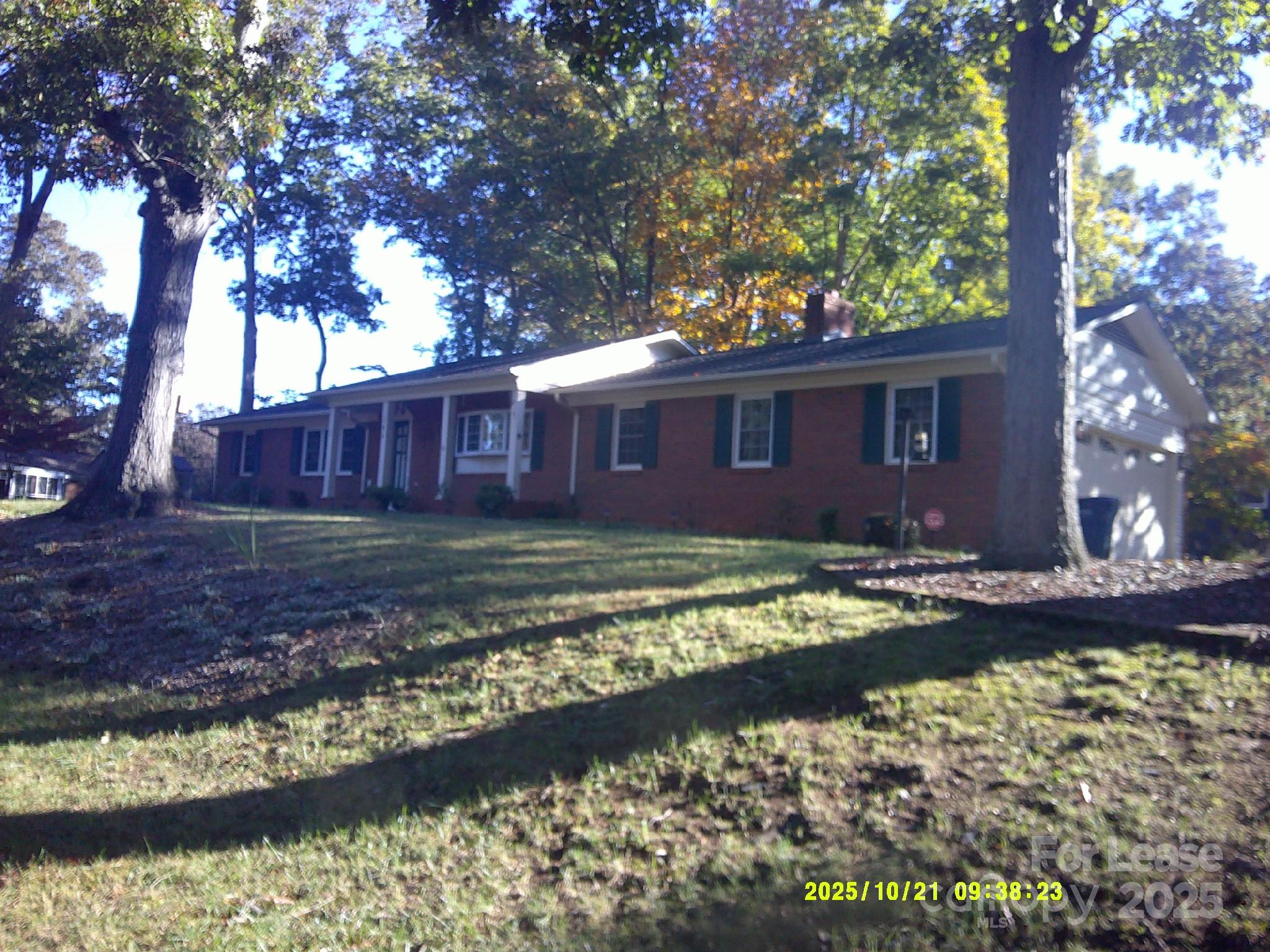 a view of a house with a yard and swimming pool