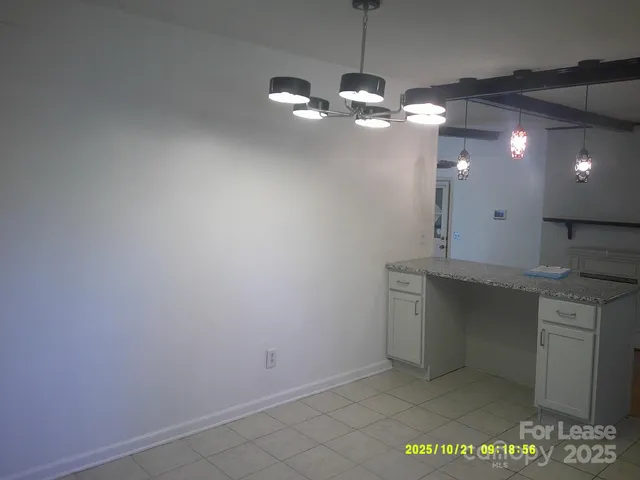 a view of a kitchen with a sink and chandelier fan