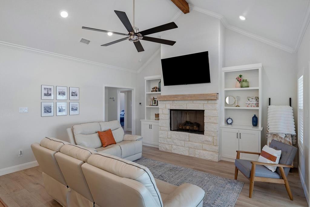 1825 Meadowview Canton, TX 75103 - Photo 17 of 36 a living room with furniture a flat screen tv and a fireplace