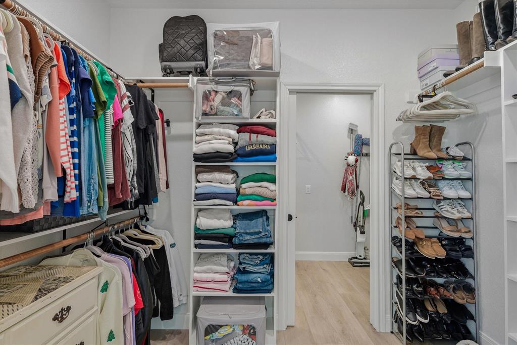 1825 Meadowview Canton, TX 75103 - Photo 27 of 36 a view of walk in closet with clothes and shoes