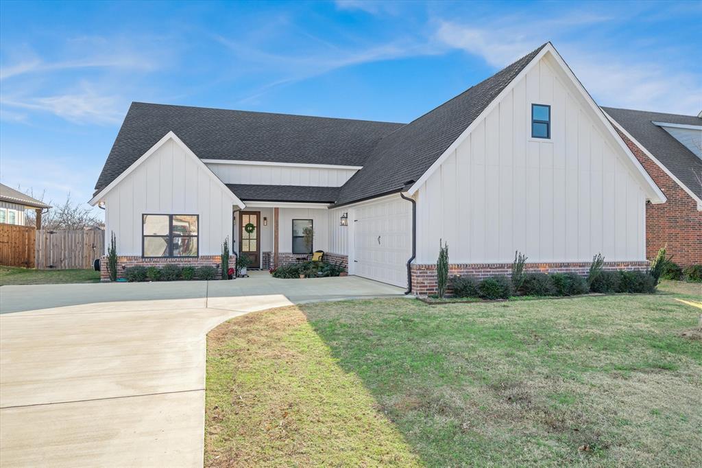 1825 Meadowview Canton, TX 75103 - Photo 3 of 36 a front view of a house with a yard and garage