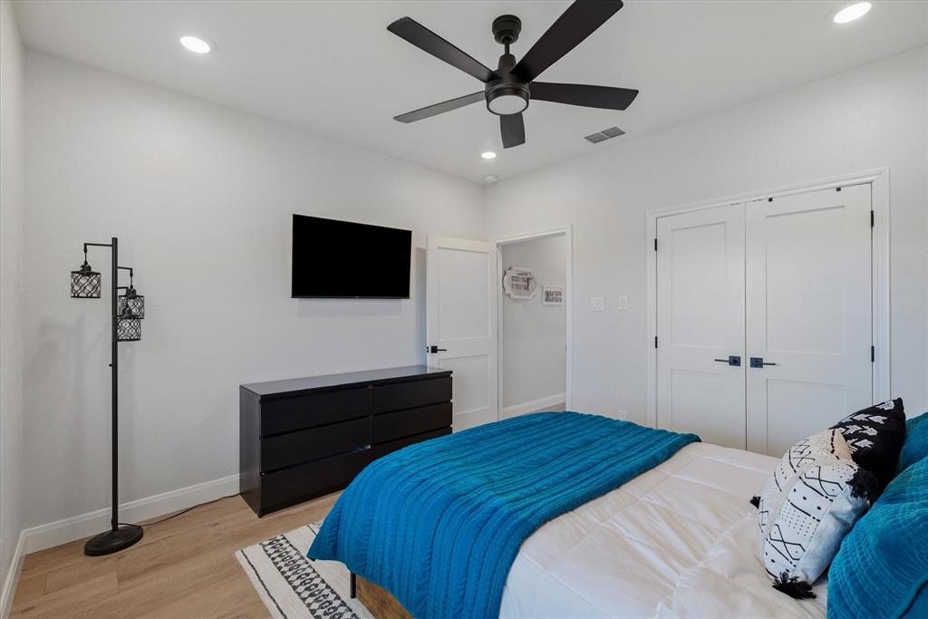 1825 Meadowview Canton, TX 75103 - Photo 10 of 36 a bedroom with a bed and a flat screen tv