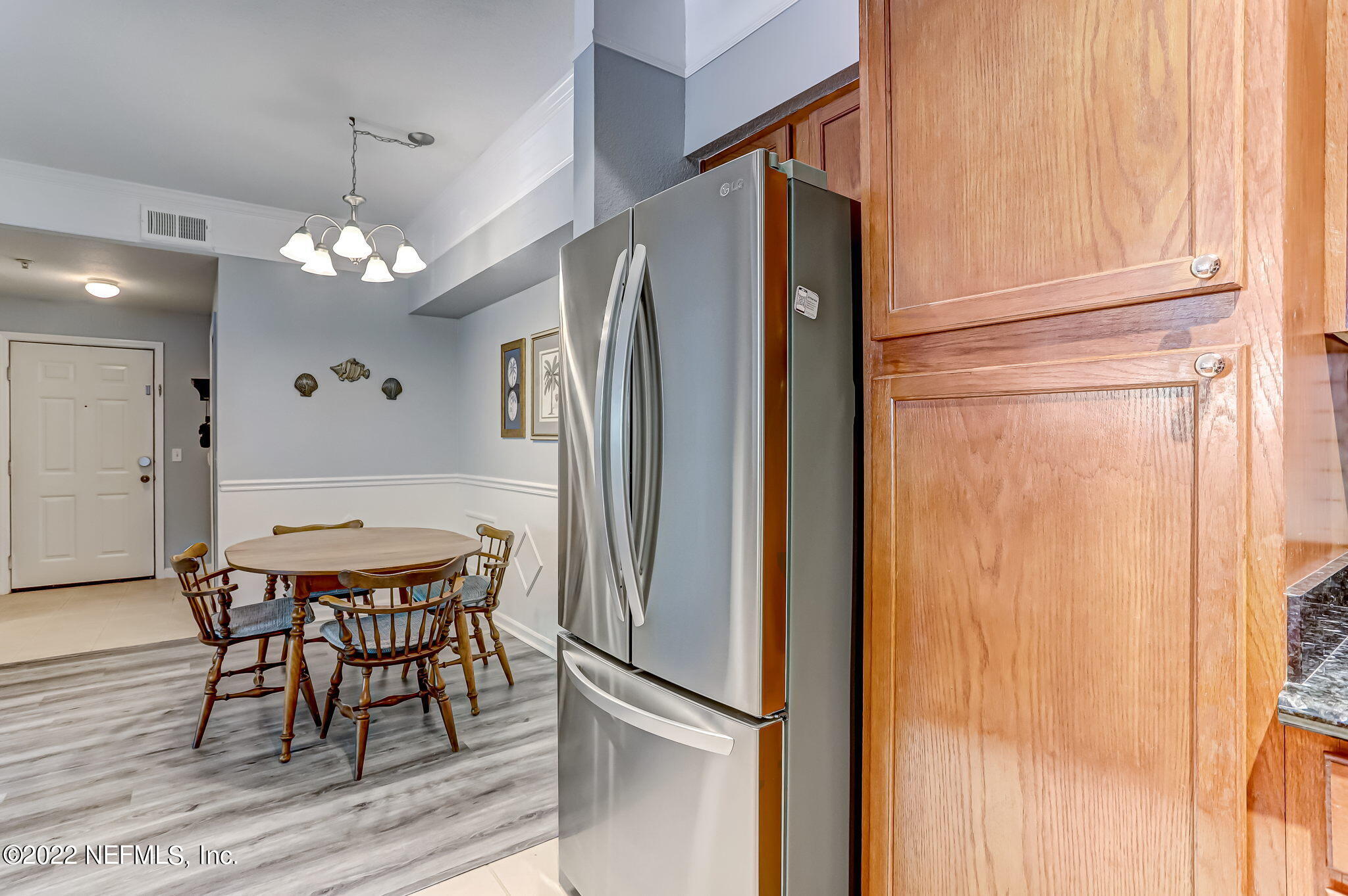 8550 Touchton Road, Unit 1117 Jacksonville, FL 32216 - Photo 18 of 61 a view of a dining room with furniture and chandelier
