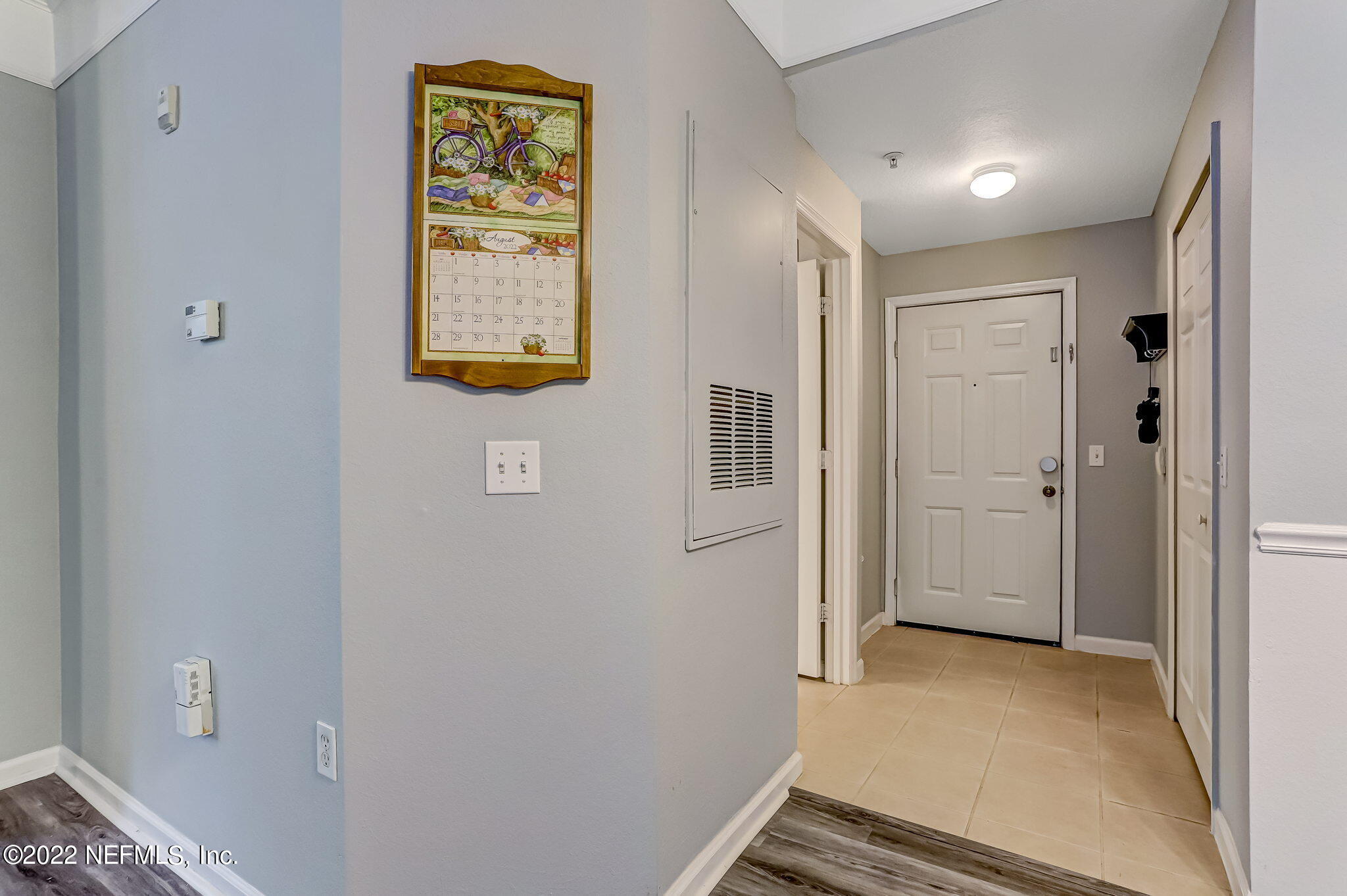 8550 Touchton Road, Unit 1117 Jacksonville, FL 32216 - Photo 4 of 61 a view of a hallway with paintings on the wall