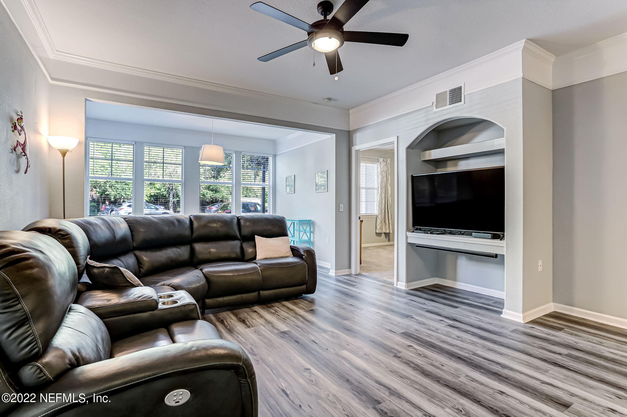 8550 Touchton Road, Unit 1117 Jacksonville, FL 32216 - Photo 8 of 61 a living room with furniture a flat screen tv and a ceiling fan
